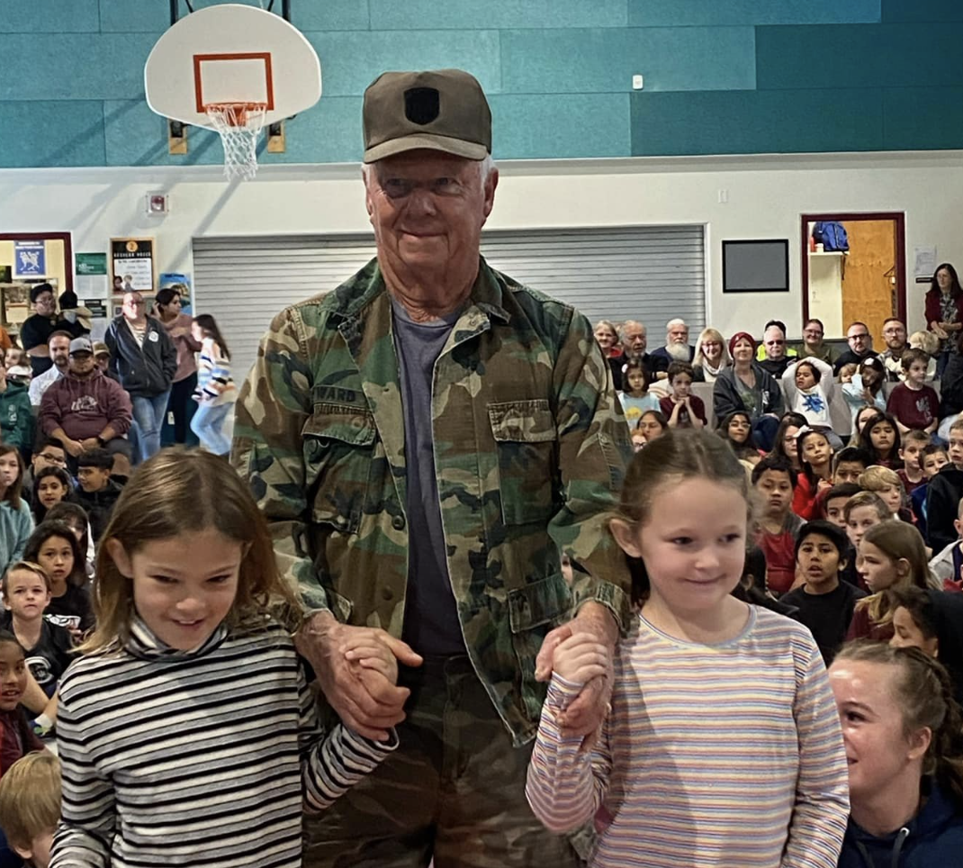 Student with a Vet at an assembly.
